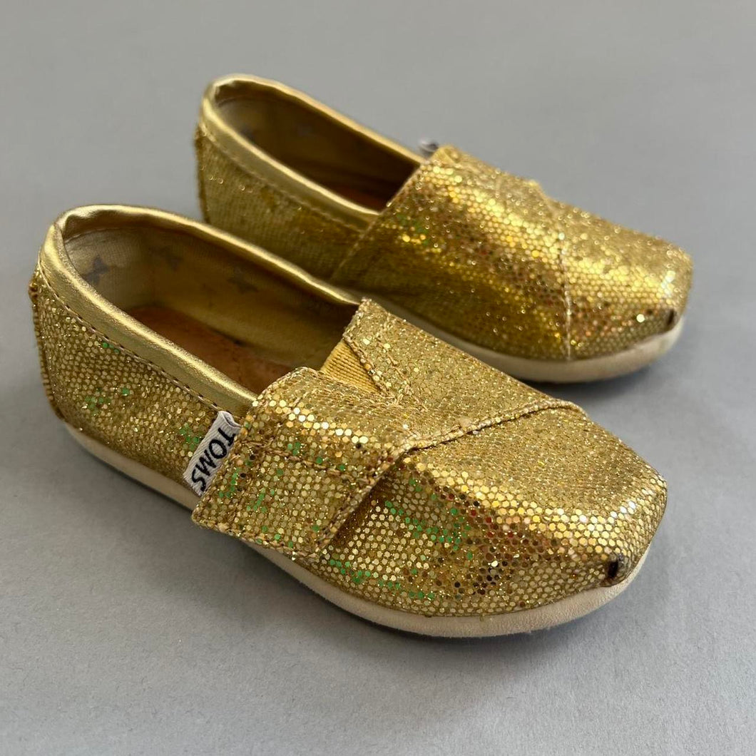 TOMS gold baby shoes