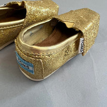Load image into Gallery viewer, TOMS gold baby shoes
